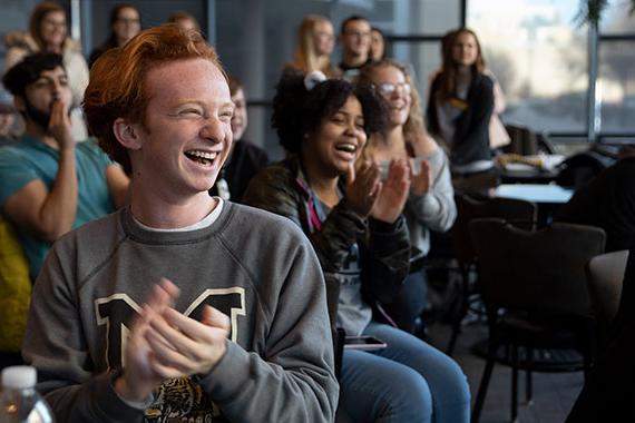 Students smiling and applauding